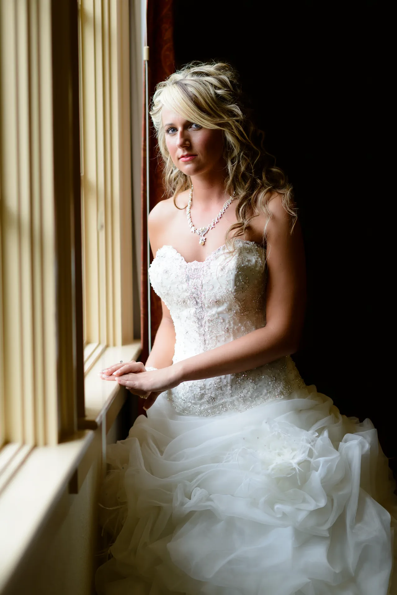 Bride standing in the window light - Members Club at Grande Dunes