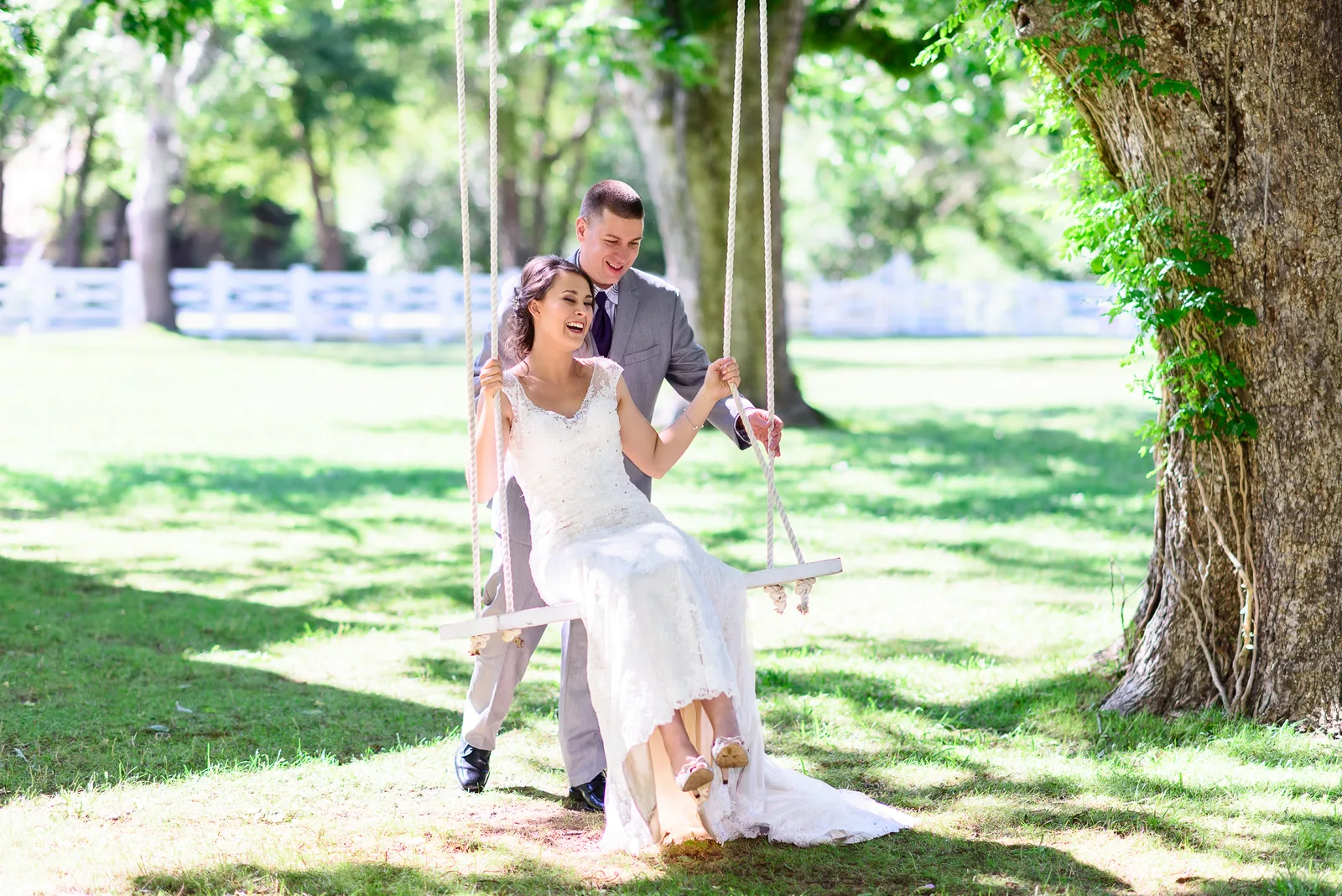 Groom pushing bride on a swing - Wildberry Farm