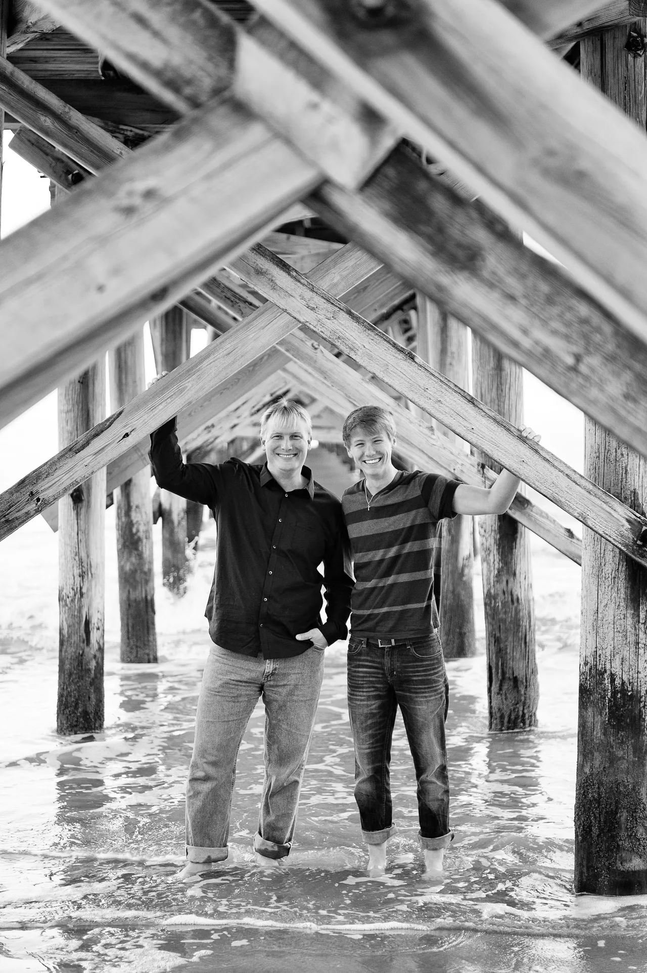Father and son under a pier - North Myrtle Beach