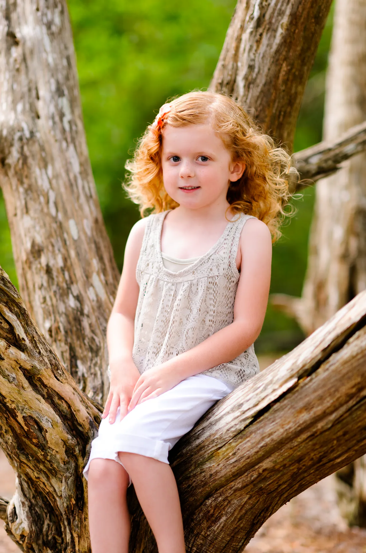 Cute little girl sitting in the oak tree - Myrtle Beach State Park