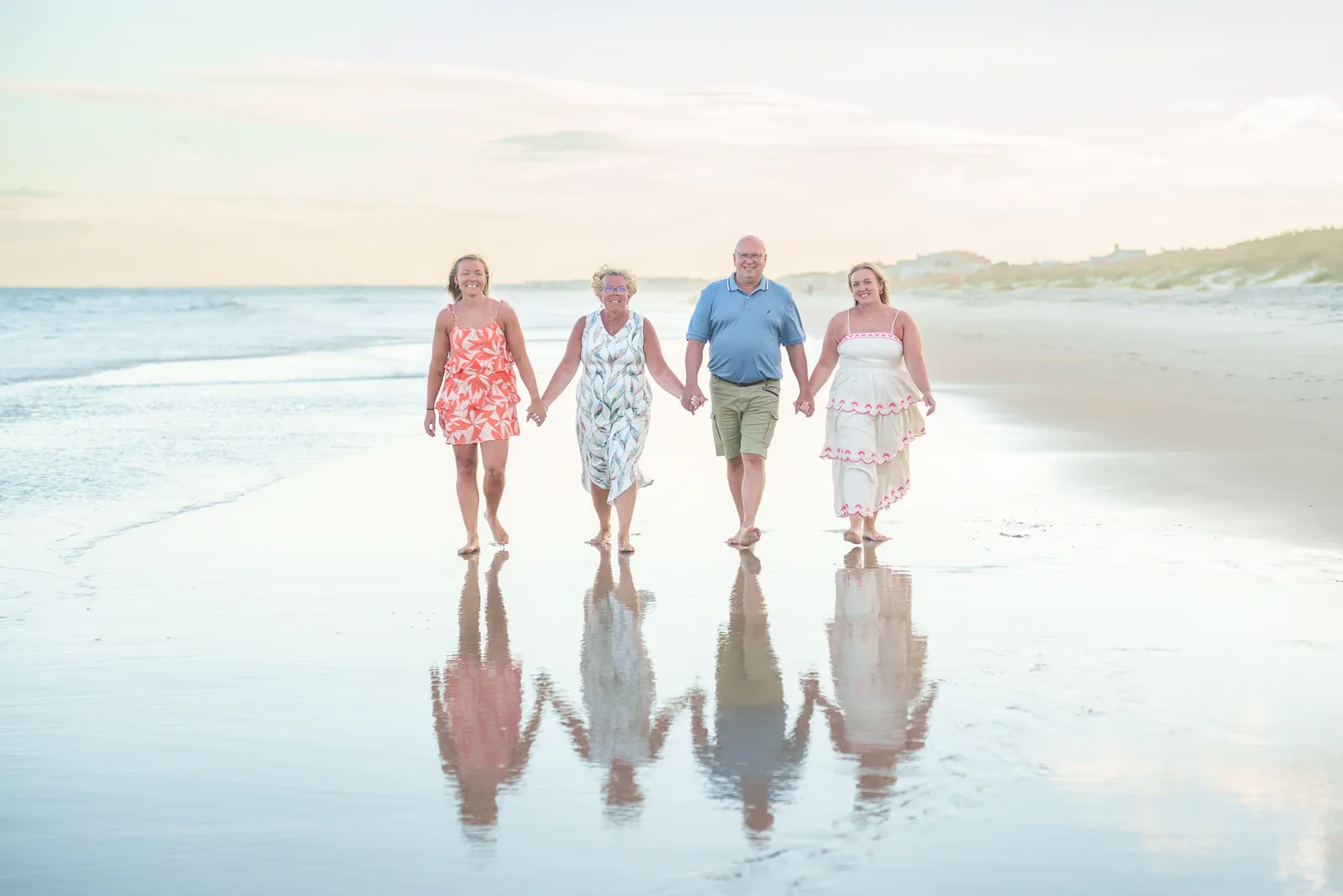 Family of 4 walking down the beach with a reflection in the edge of the ocean - Huntington Beach State Park