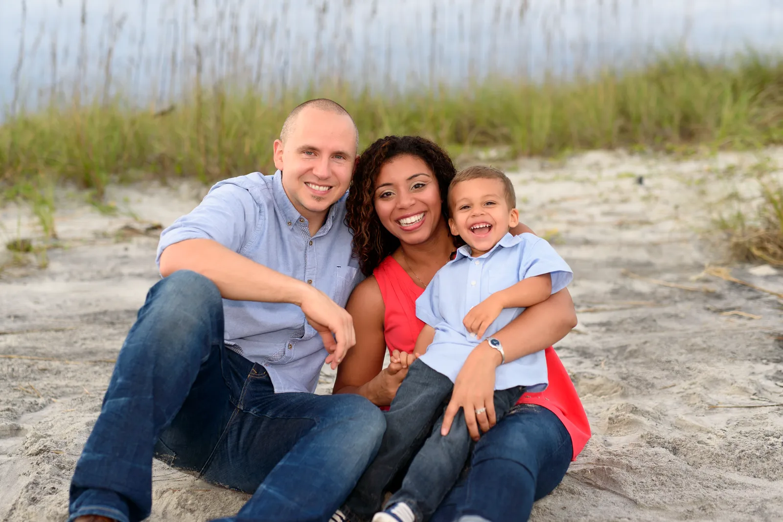 Family of three sitting on the beach - Myrtle Beach State Park