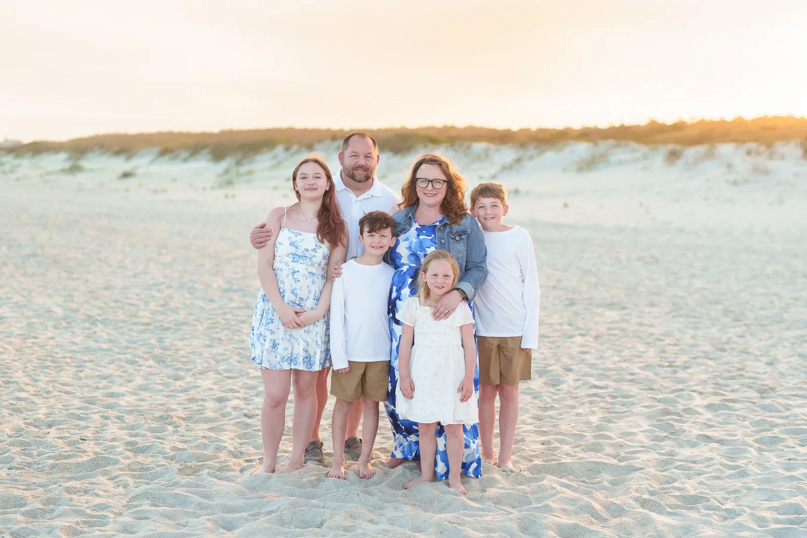 Happy family of 6 in front of the sunset and dunes - Huntington Beach State Park