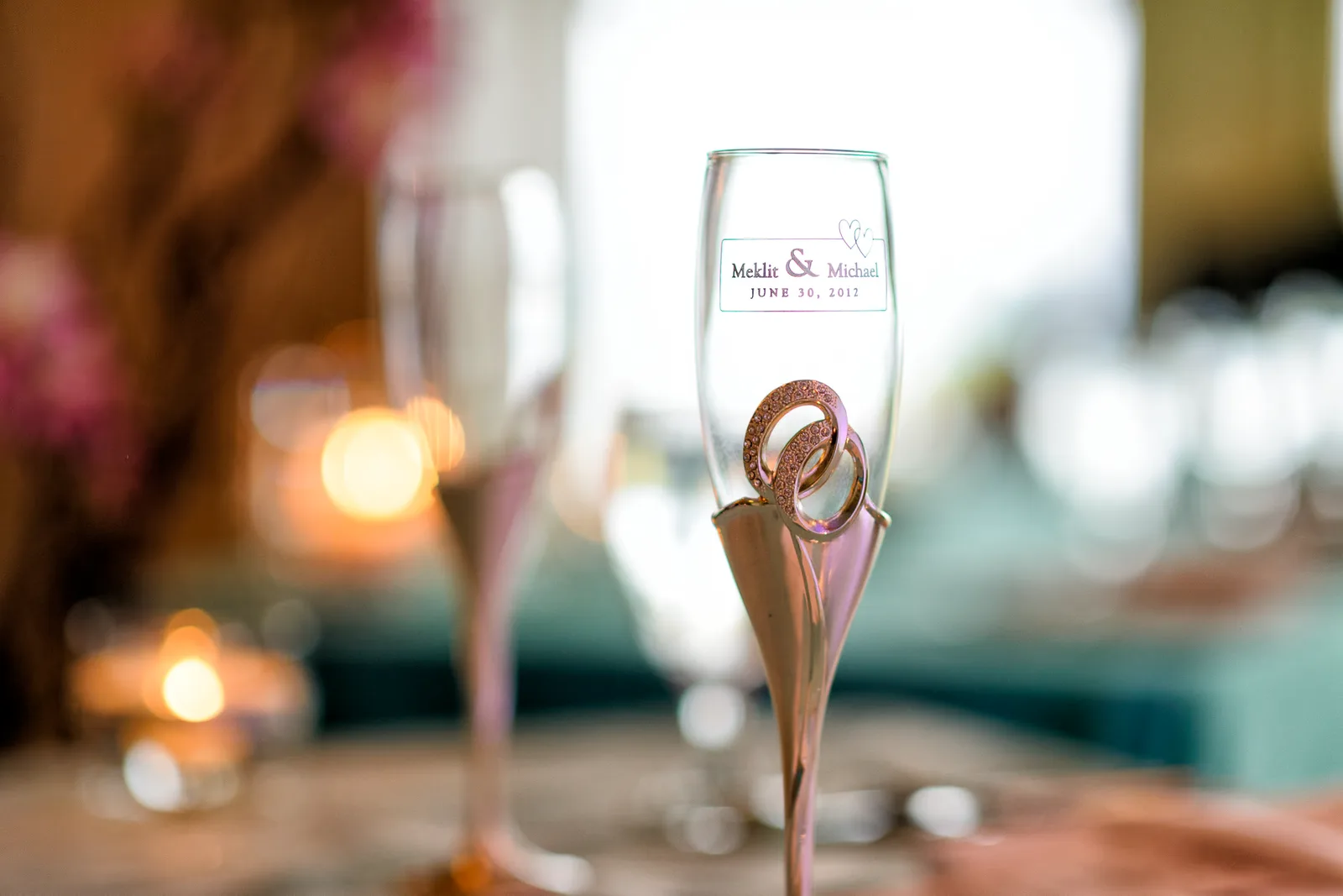 Closeup of wine glasses with couple's names -