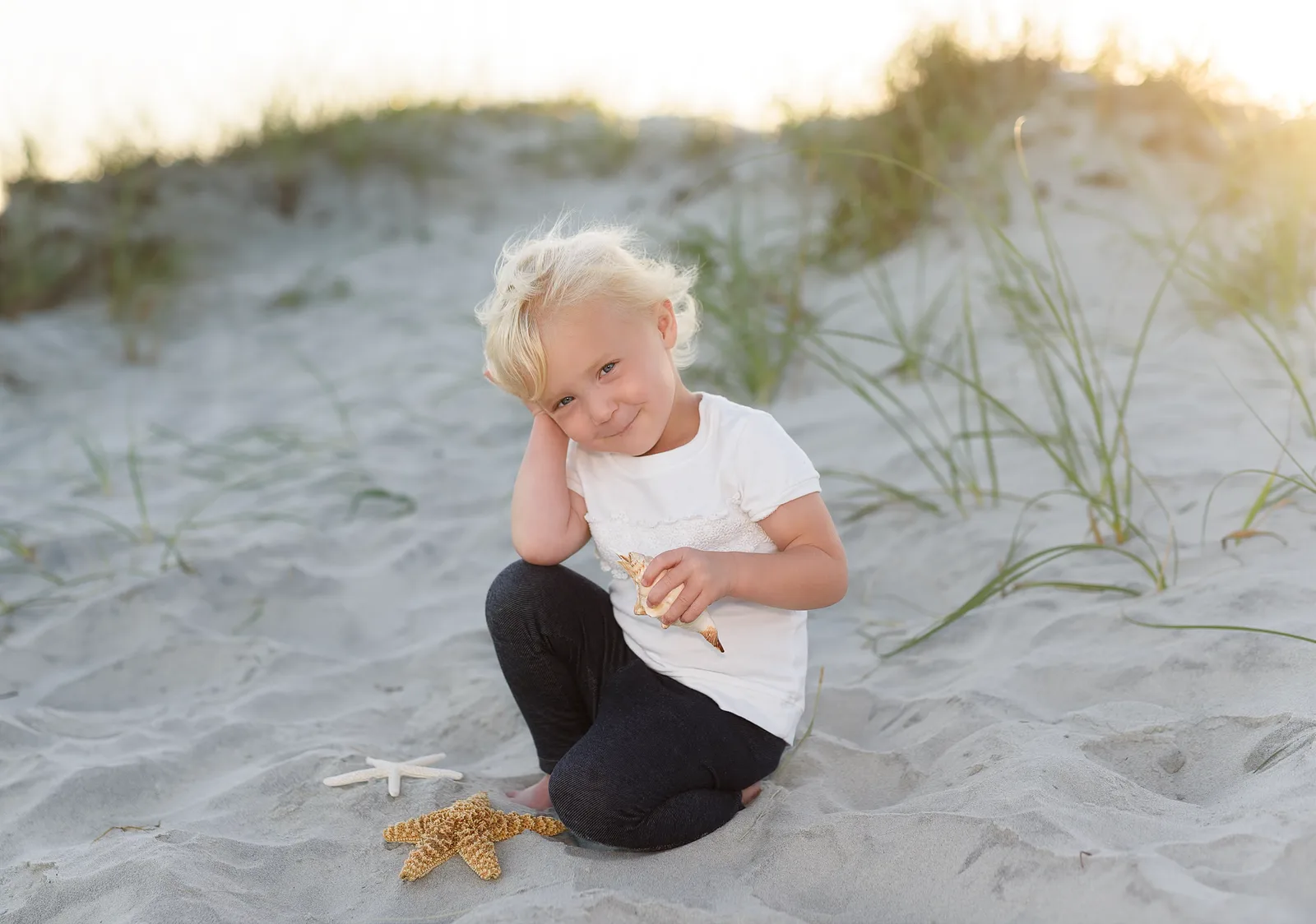Baby girl having fun with shells by the dunes - Myrtle Beach State Park