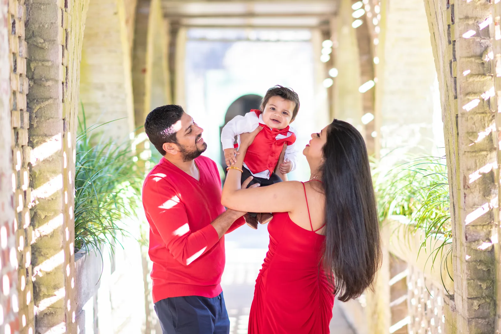 Mom and dad holding baby boy in the air - Atalaya Castle