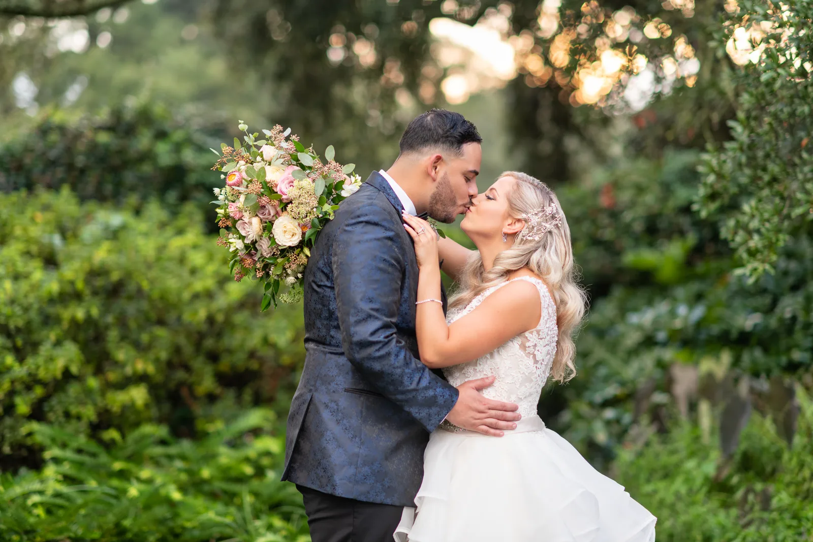 Bride and groom in front of beautiful greenery and sunset - Litchfield Country Club