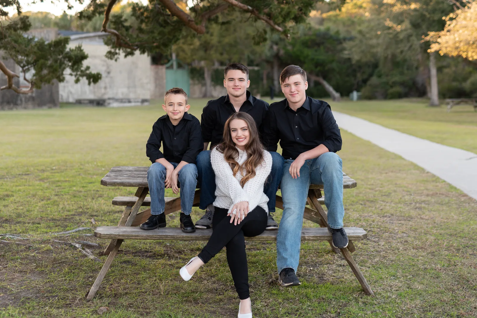 3 brothers with their sister sitting on the picnic table - Atalaya Castle