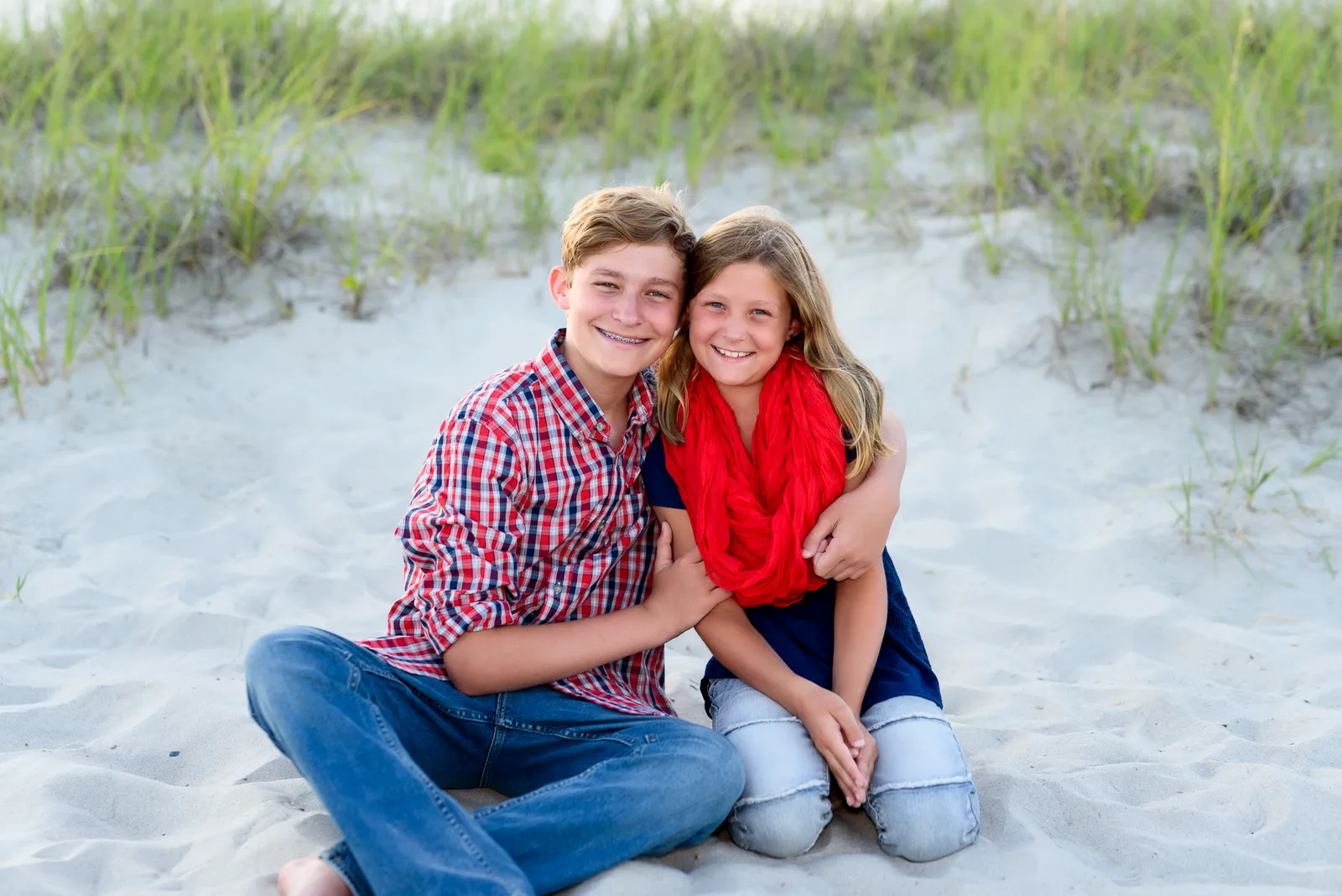 Brother with little sister sitting by the dunes - Myrtle Beach State Park