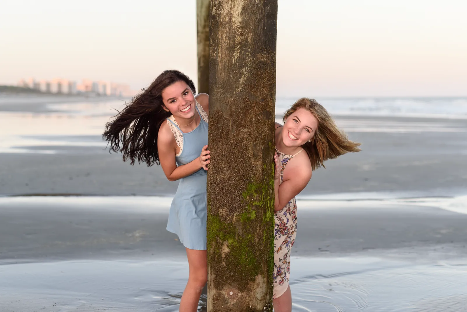 Best friends peeking around the pier - Myrtle Beach State Park Pier