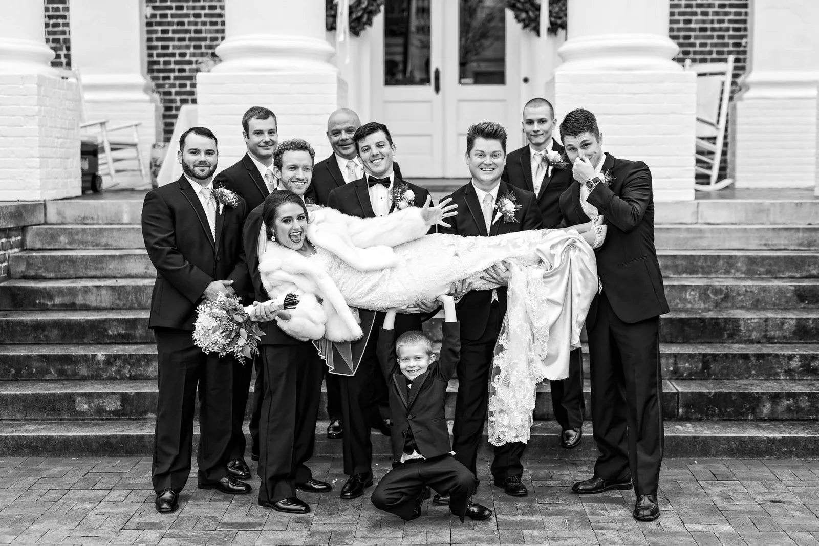Groom and groomsmen having fun lifting up the bride - Rosewood Manor, Marion