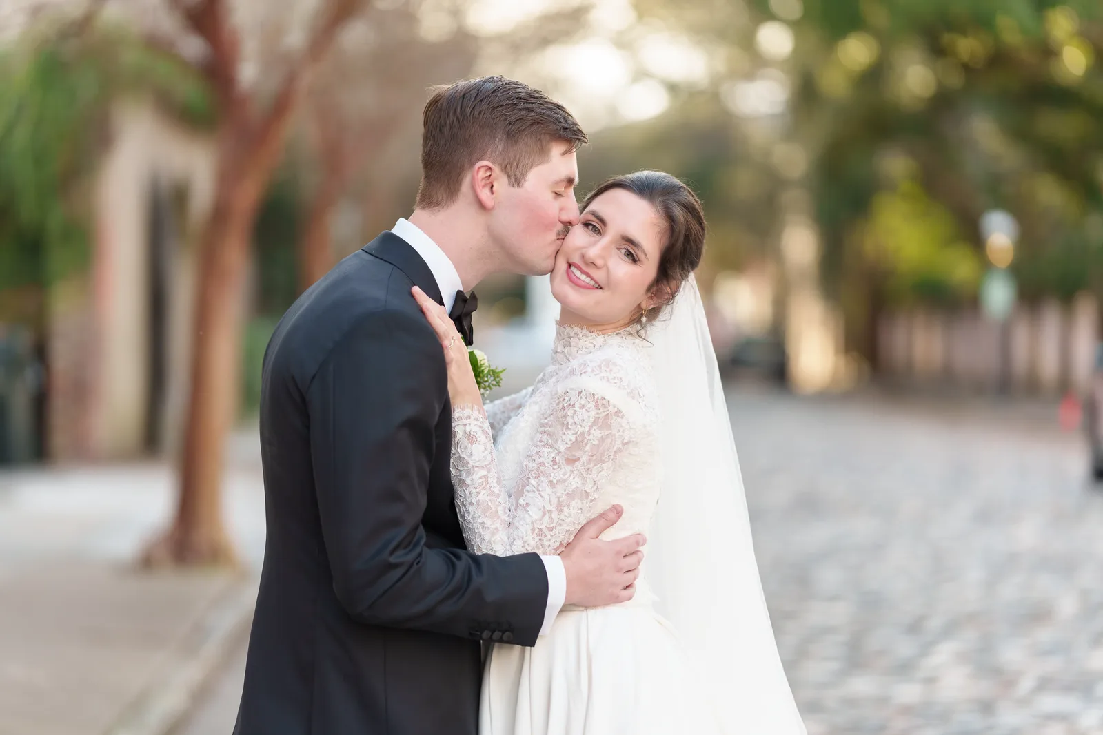 Kiss on the cheek with bride looking at the camera - Chalmers Street