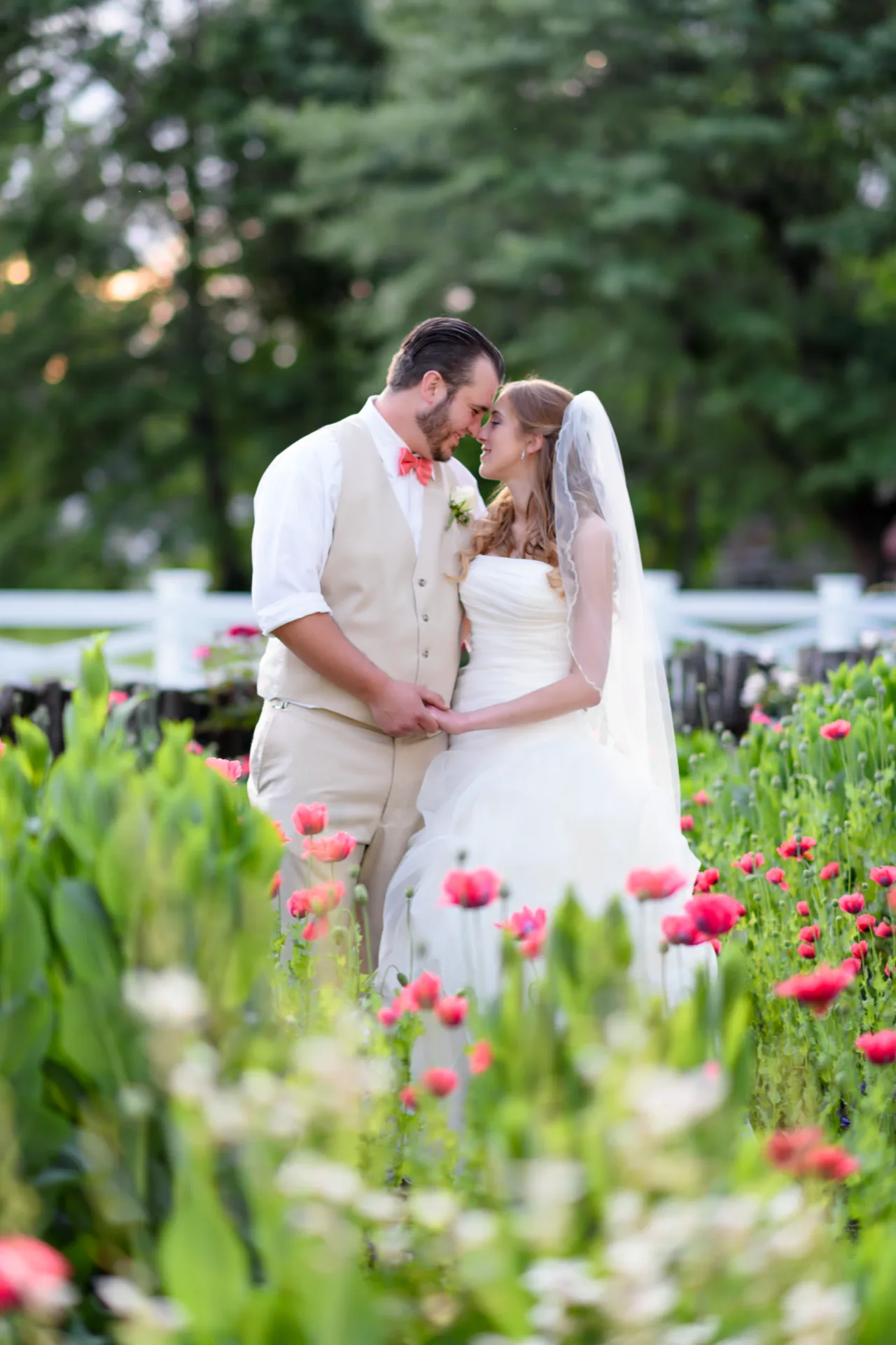 Couple looking at each other surrounded by flowers - Wildberry Farm