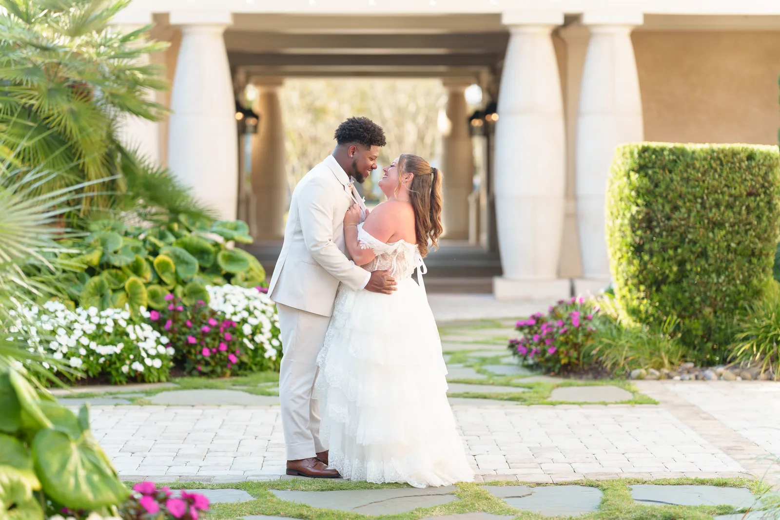 Pulling groom in for a kiss in the courtyard - 21 Main Events