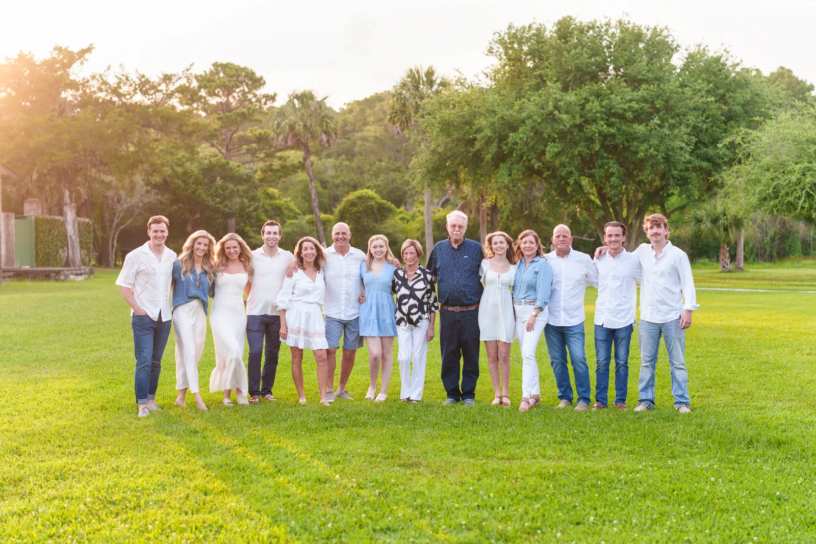 Big family with adult children in front of the palms - Huntington Beach State Park