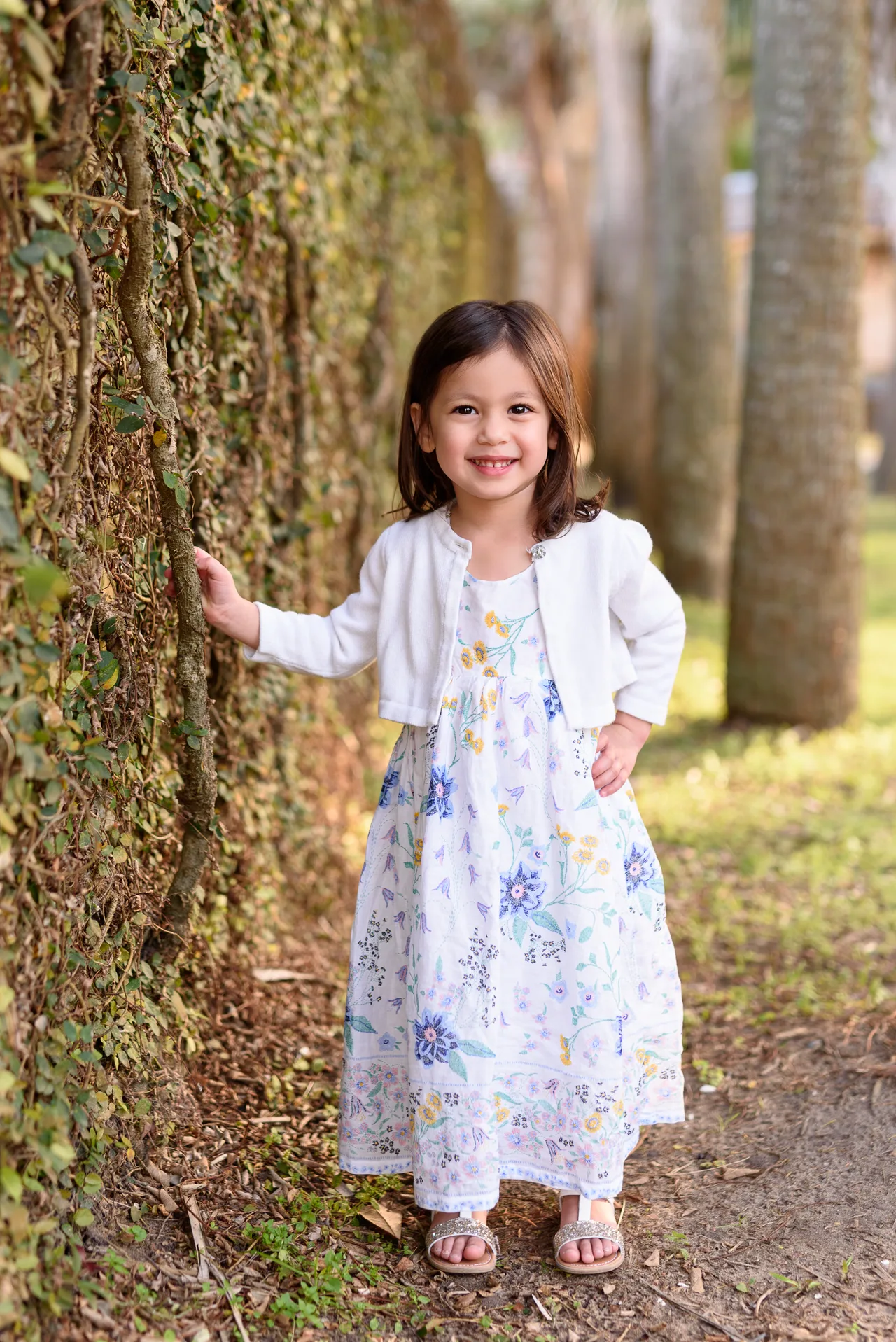 Little girl leaning against the ivy wall - Atalaya Castle