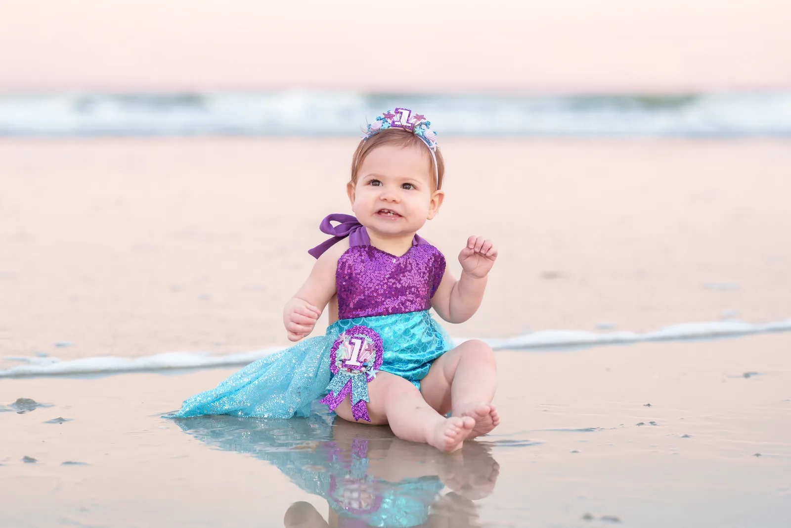 1 year old in birthday dress sitting in the ocean - North Myrtle Beach