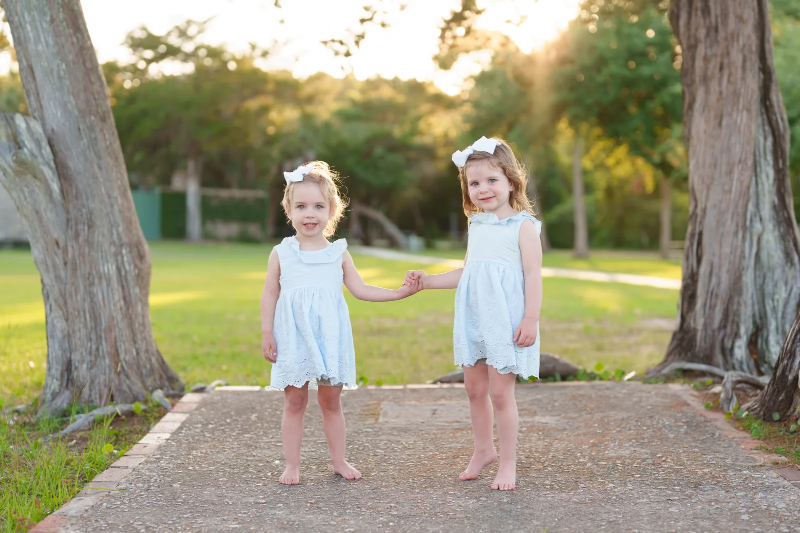 Sisters holding hands in the sunset - Huntington Beach State Park