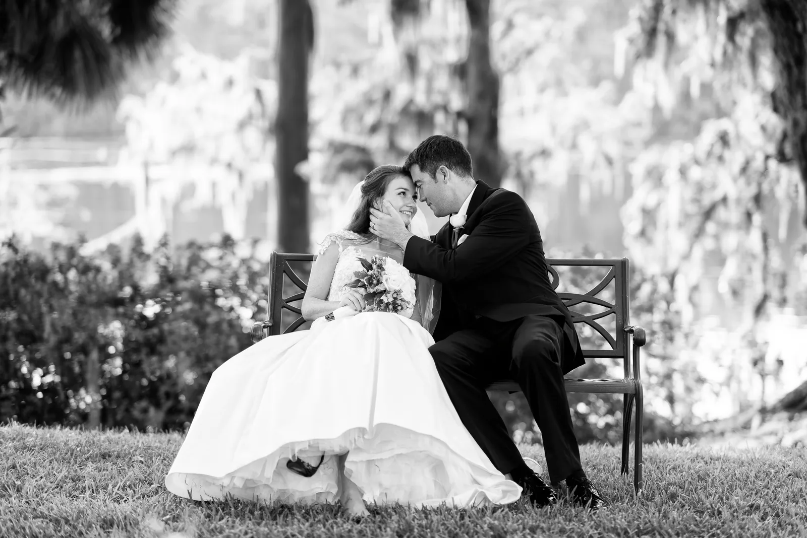 Cute couple sitting on a bench by the river - Wachesaw Plantation