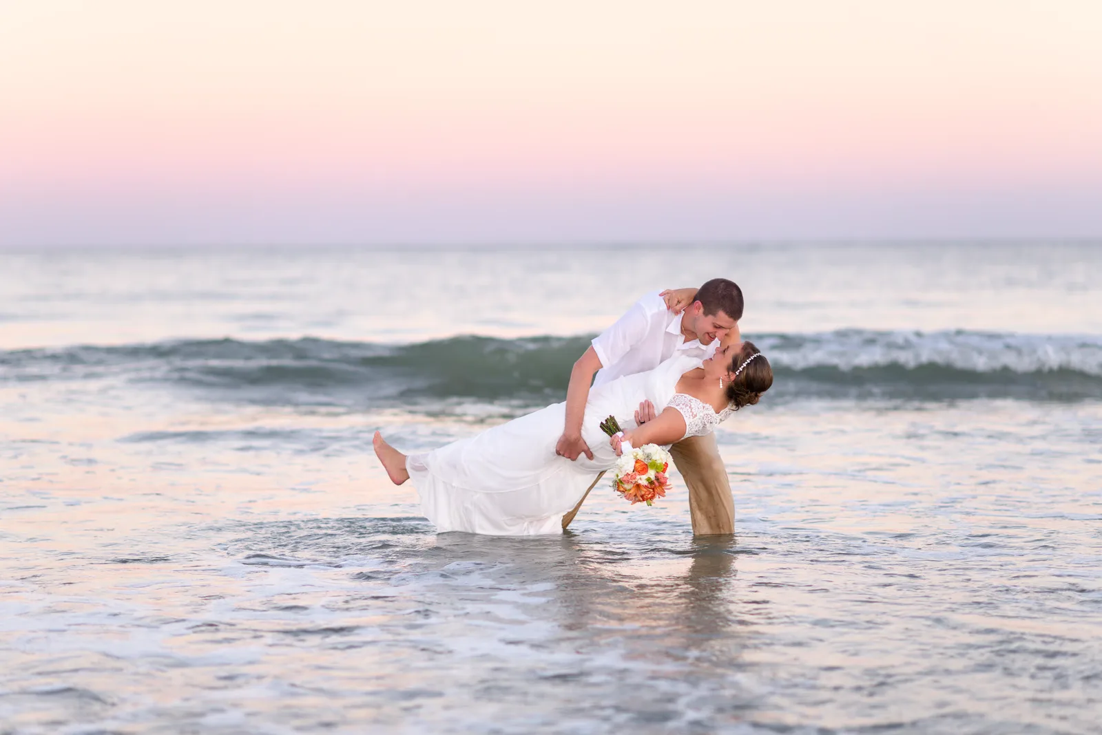 Dipping bride into ocean at sunset - Myrtle Beach