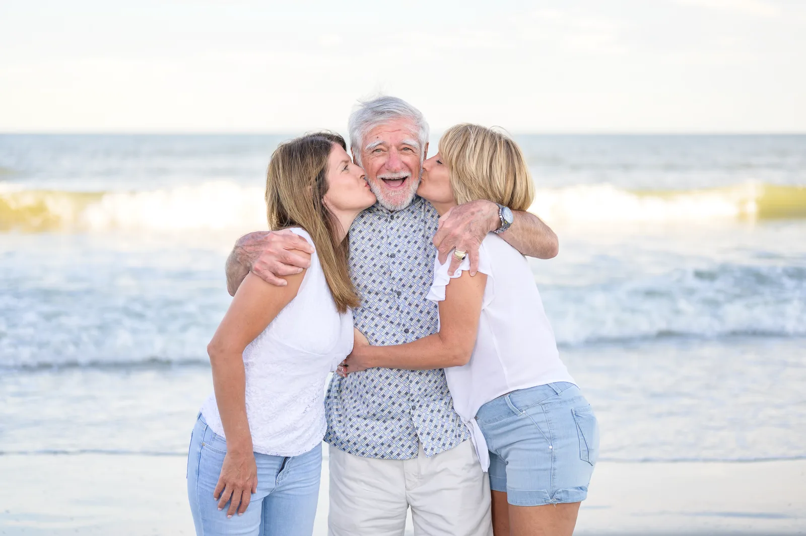 Dad getting a kiss form his daughters  - Garden City Pier