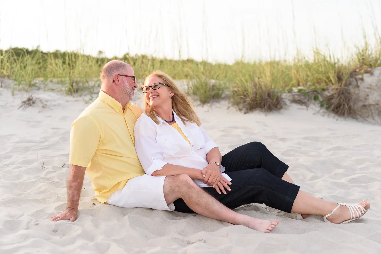Grandparents sitting together by the dunes - Myrtle Beach State Park