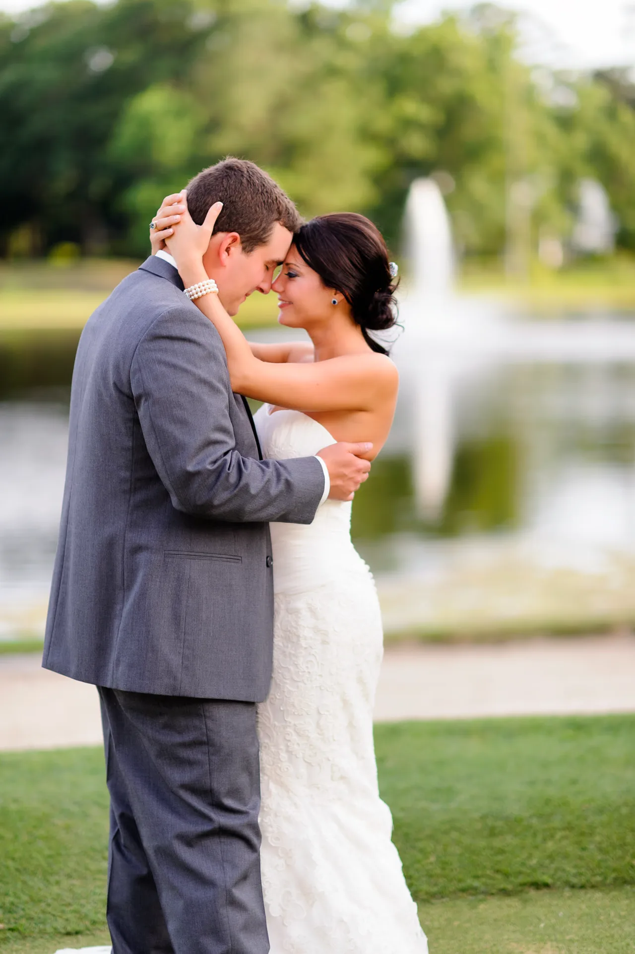 Couple with foreheads together by the golf course lake - Pawleys Plantation