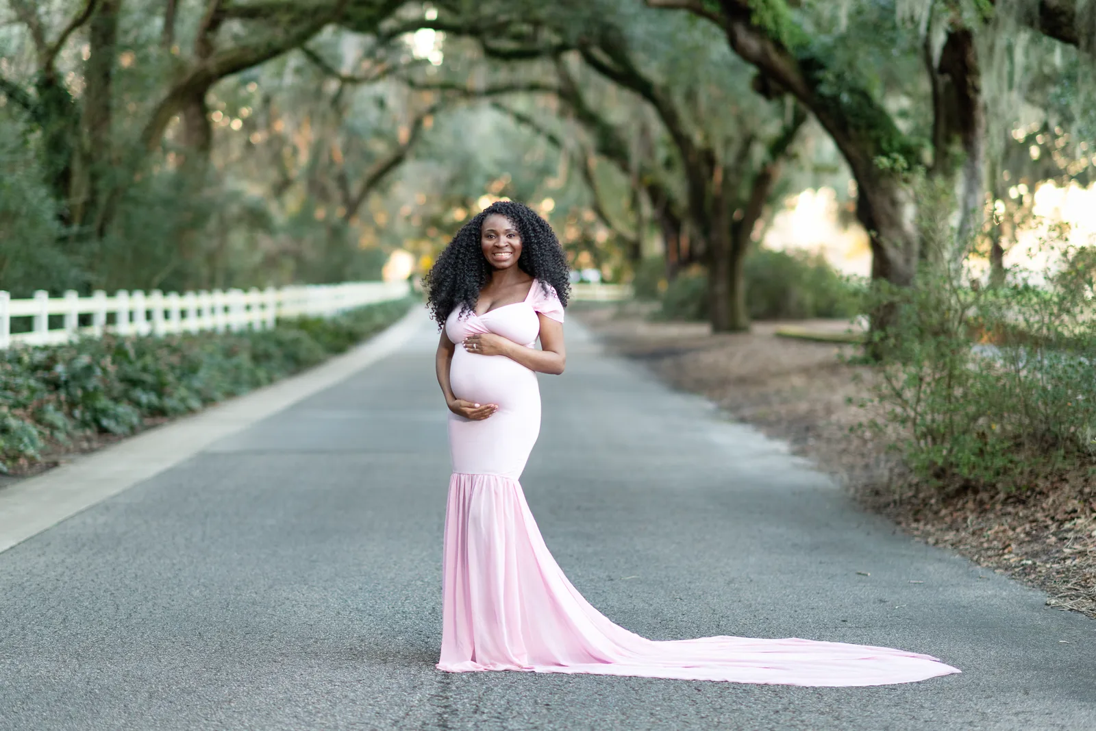 Portrait of mother touching her belly under the mossy oaks - Caledonia Golf & Fish Club