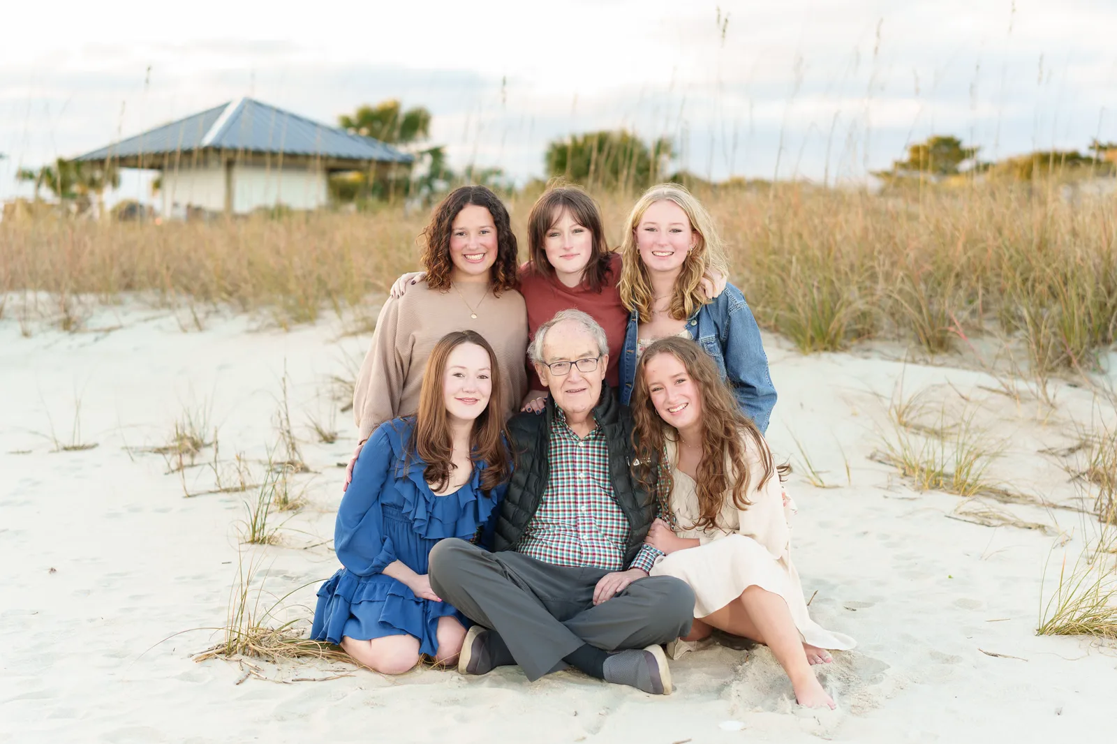 Granddaughters with thier grandfather sitting on the beach with thier grandfather sitting on the beach - DeBordieu Colony