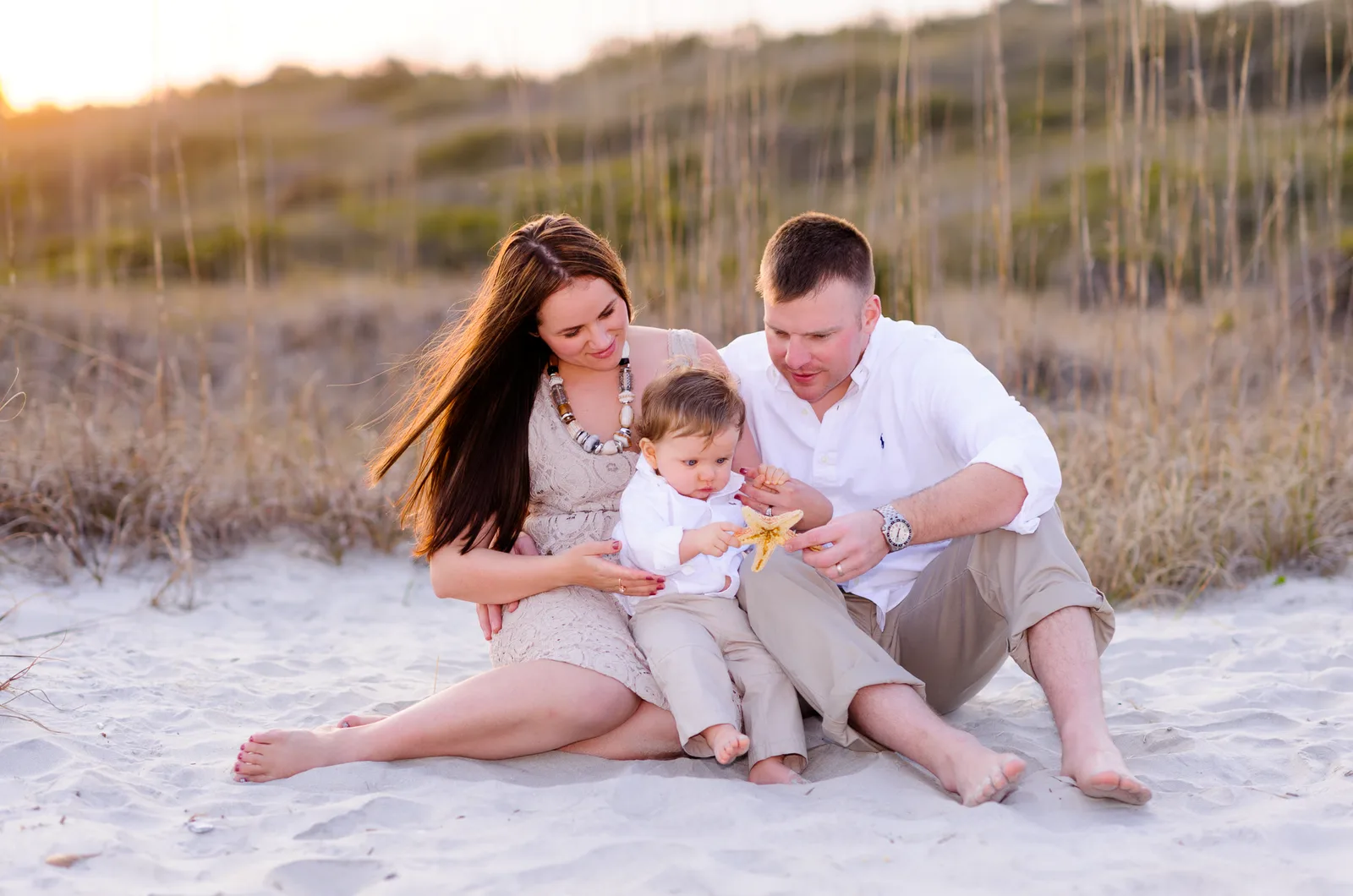 Family with little boy looking at starfish - Myrtle Beach State Park
