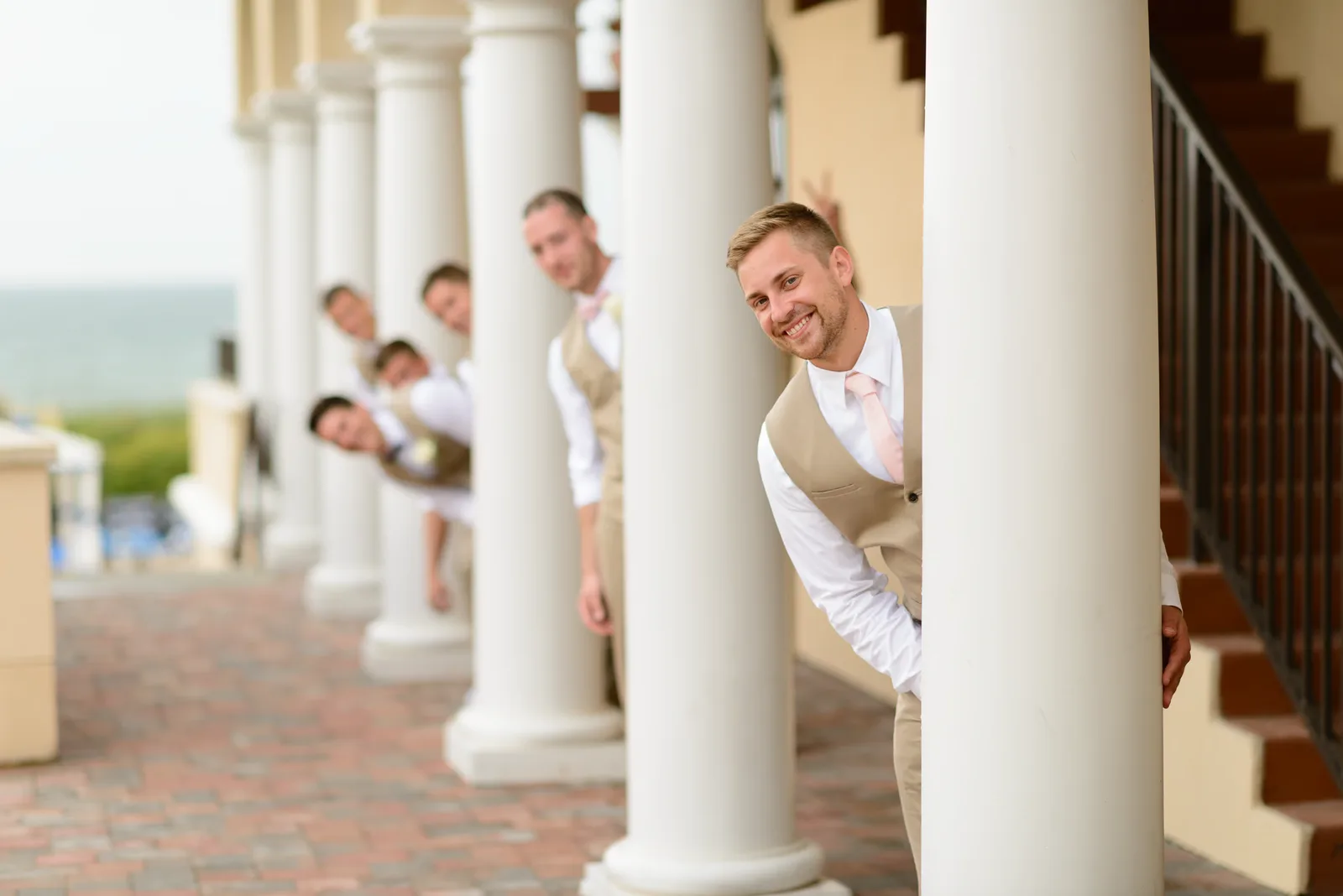 Groomsmen having fun peeking out behind the columns - Ocean Club, Myrtle Beach