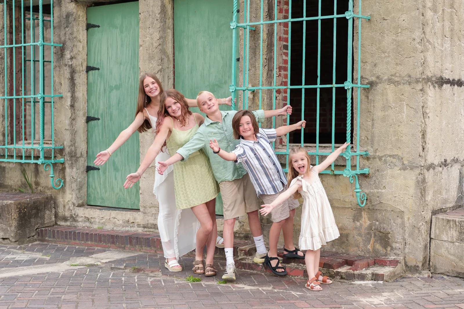 Cousins having fun hanging from the Atalaya Castle window. - Huntington Beach State Park