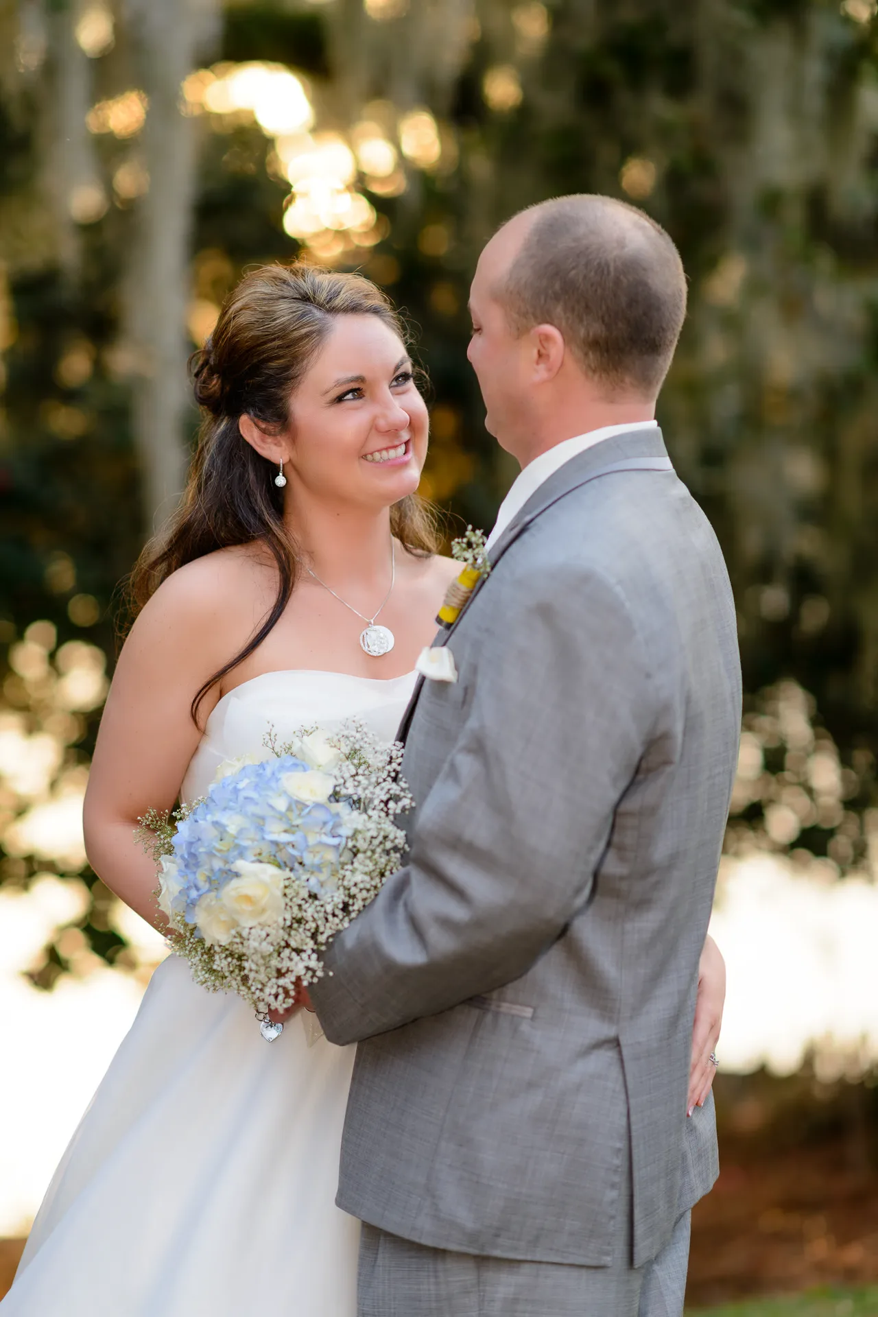 Bride smiling up a groom at sunset - Wachesaw Plantation