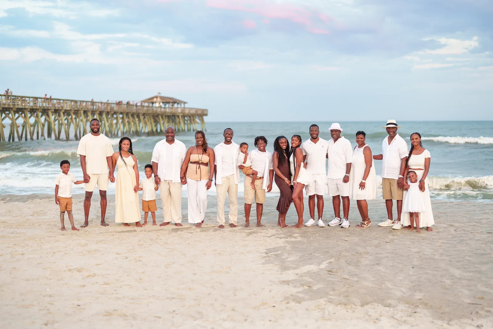 Big family standing in front of the ocean and pier - Myrtle Beach State Park