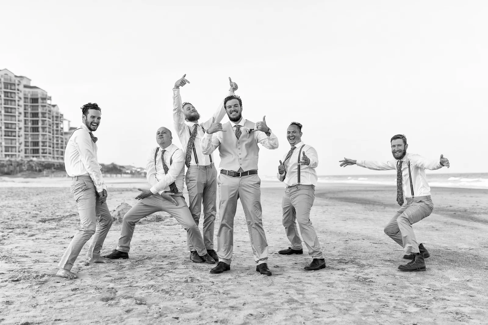 Groom having fun posing with the guys by the ocean - Grande Dunes Ocean Club - Myrtle Beach