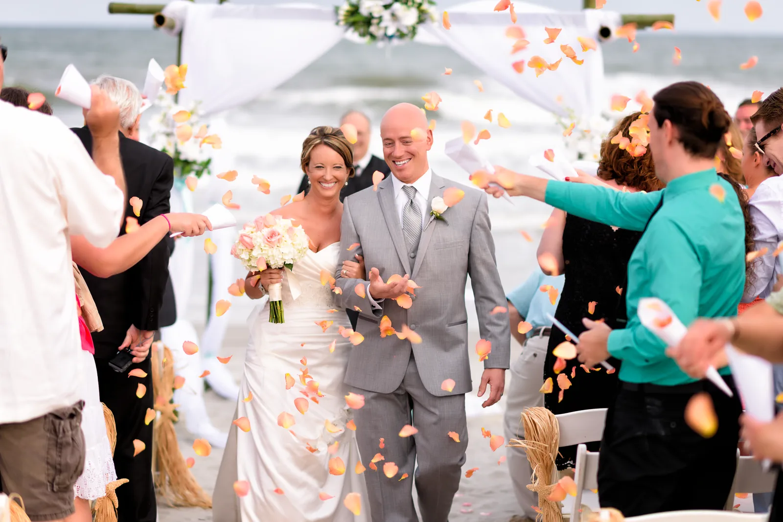 Couple walking down isle with flower petals being thrown - Myrtle Beach