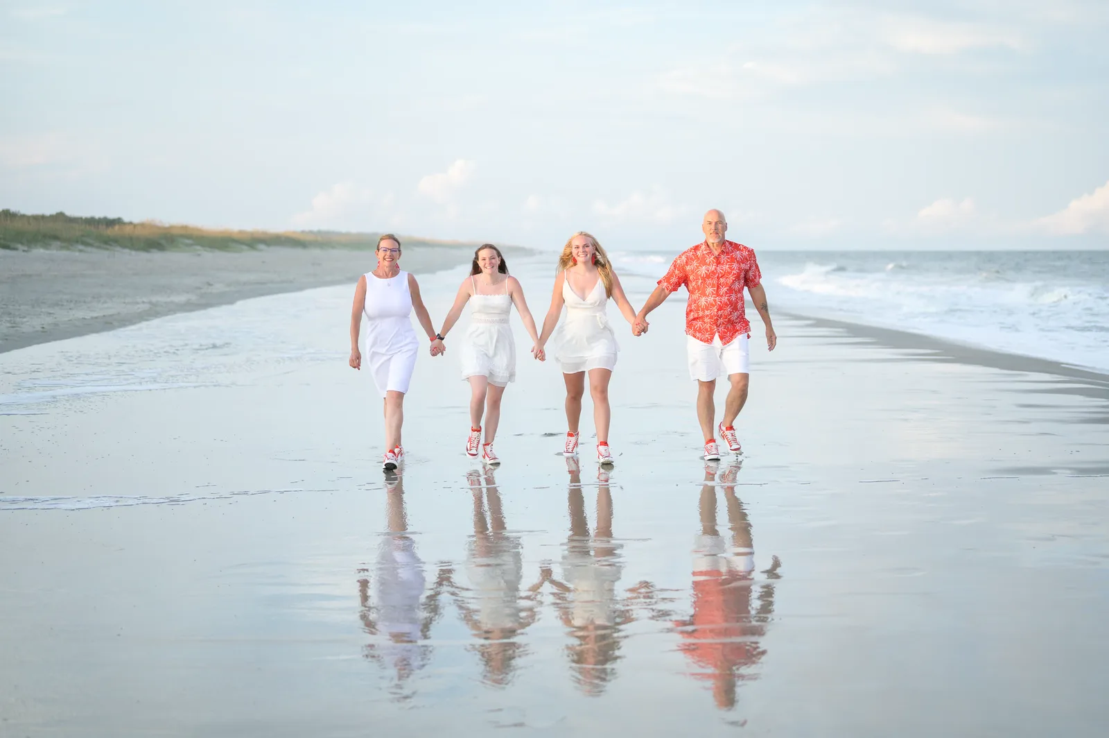 Family of 4 reflecting in the water - Huntington Beach State Park