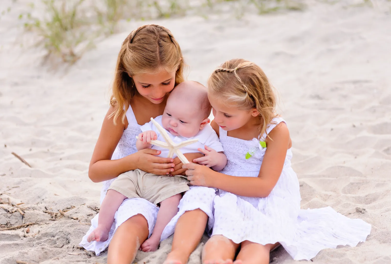 Sisters showing starfish to baby brother - Myrtle Beach State Park