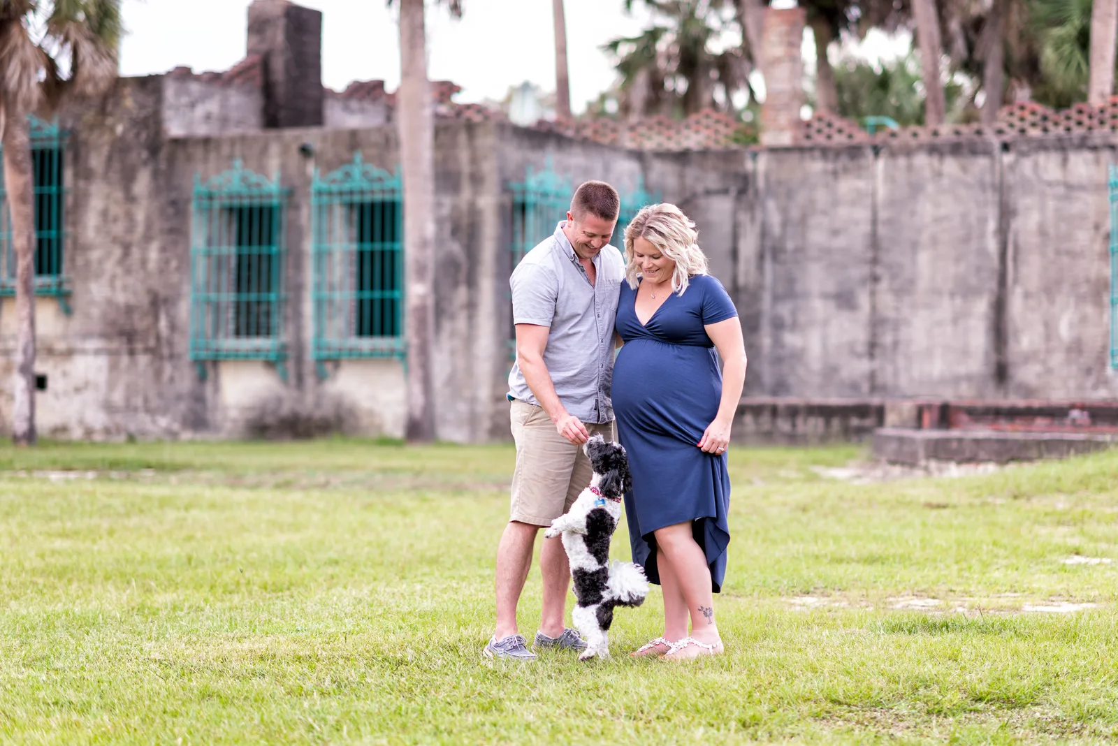 Maternity portraits behind the castle with their dog - Huntington Beach State Park