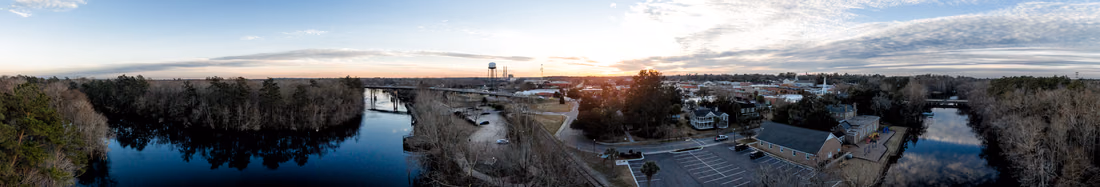 Drone panorama of the Waccamaw River and downtown Conway at sunset