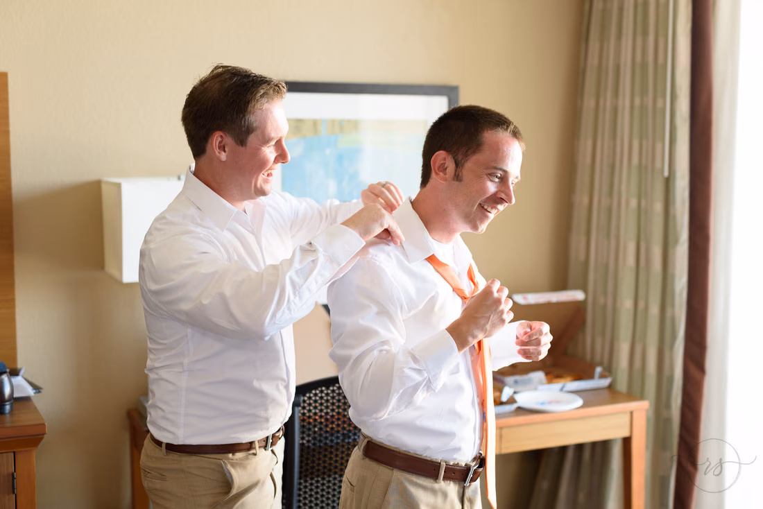 Best man helping groom with tie - Hilton Myrtle Beach Resort at Kingston Resorts