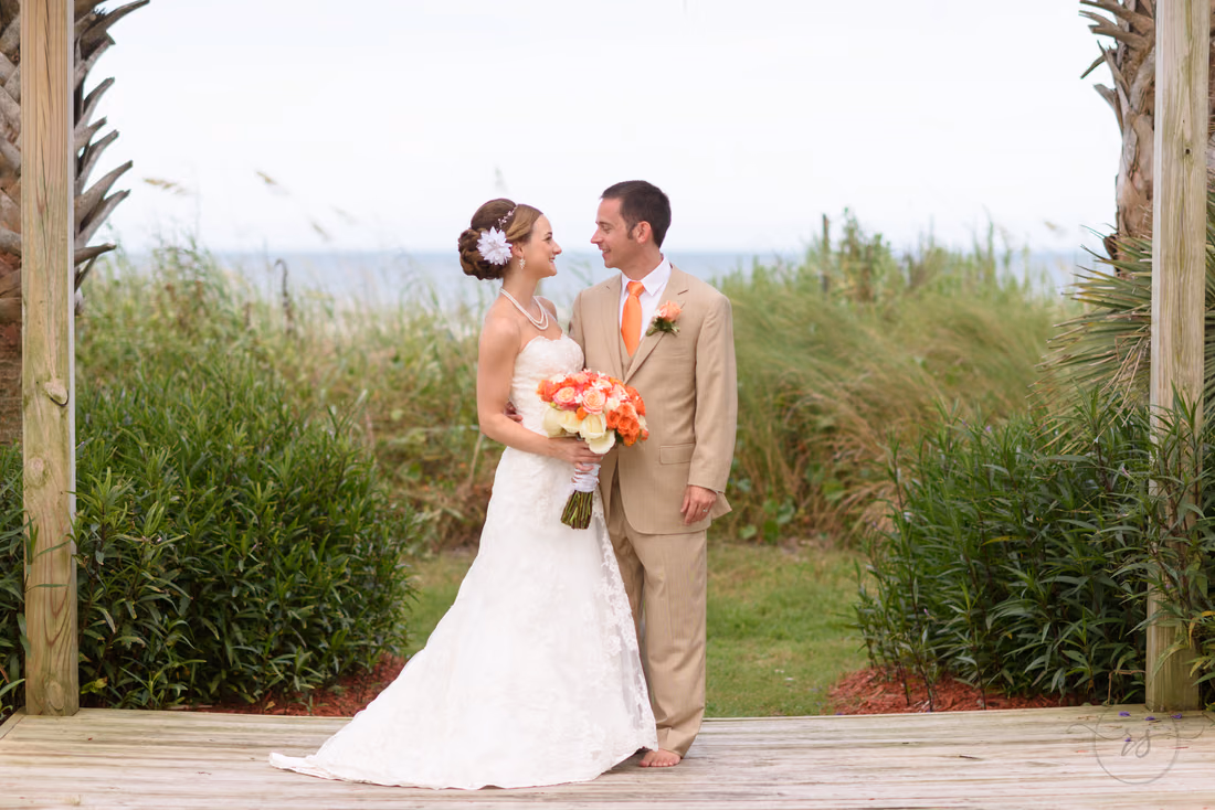 Bride and groom smiling at each other - Hilton Myrtle Beach Resort at Kingston Resorts