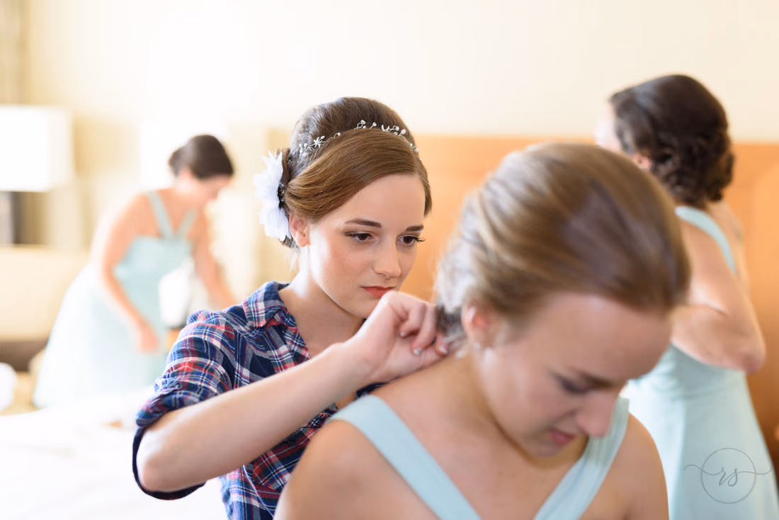 Bride helping bridesmaid with dress - Hilton Myrtle Beach Resort at Kingston Resorts