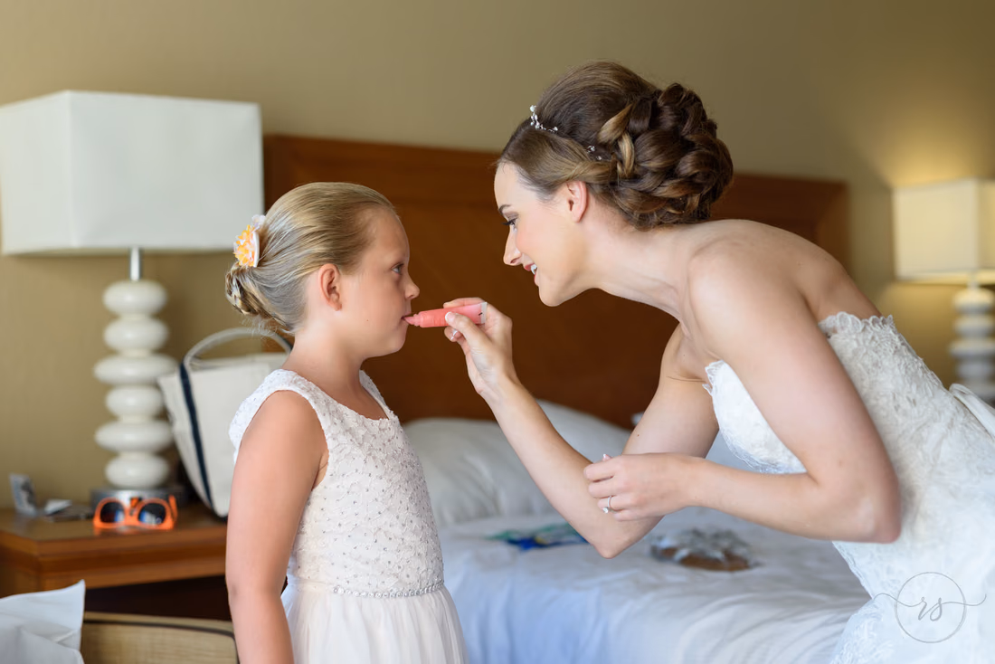 Bride helping flower girl with makeup - Hilton Myrtle Beach Resort at Kingston Resorts