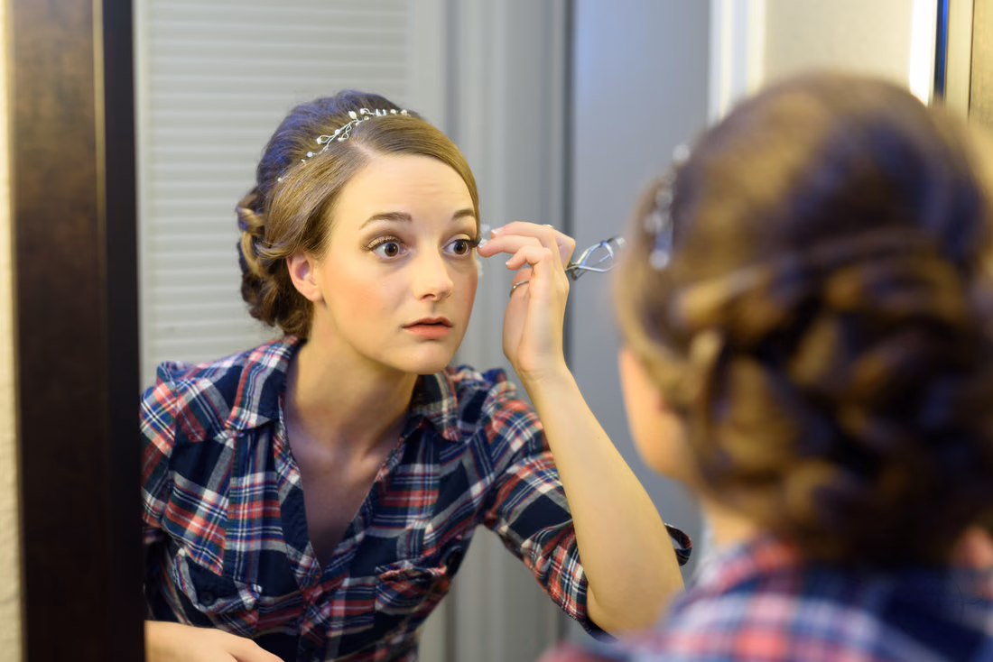Bride working on makeup in mirror - Hilton Myrtle Beach Resort at Kingston Resorts