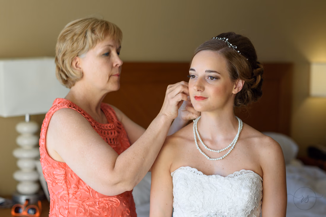 Bride's mom putting on bride's earrings - Hilton Myrtle Beach Resort at Kingston Resorts