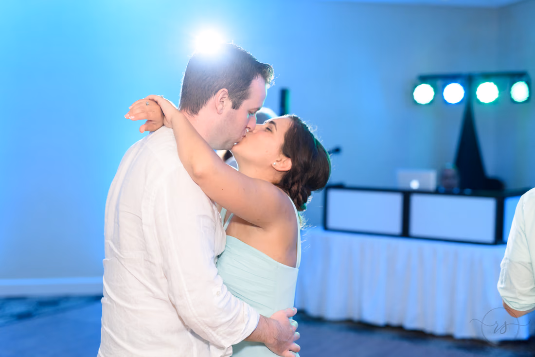 Bridesmaid kissing husband during dancing - Hilton Myrtle Beach Resort at Kingston Resorts