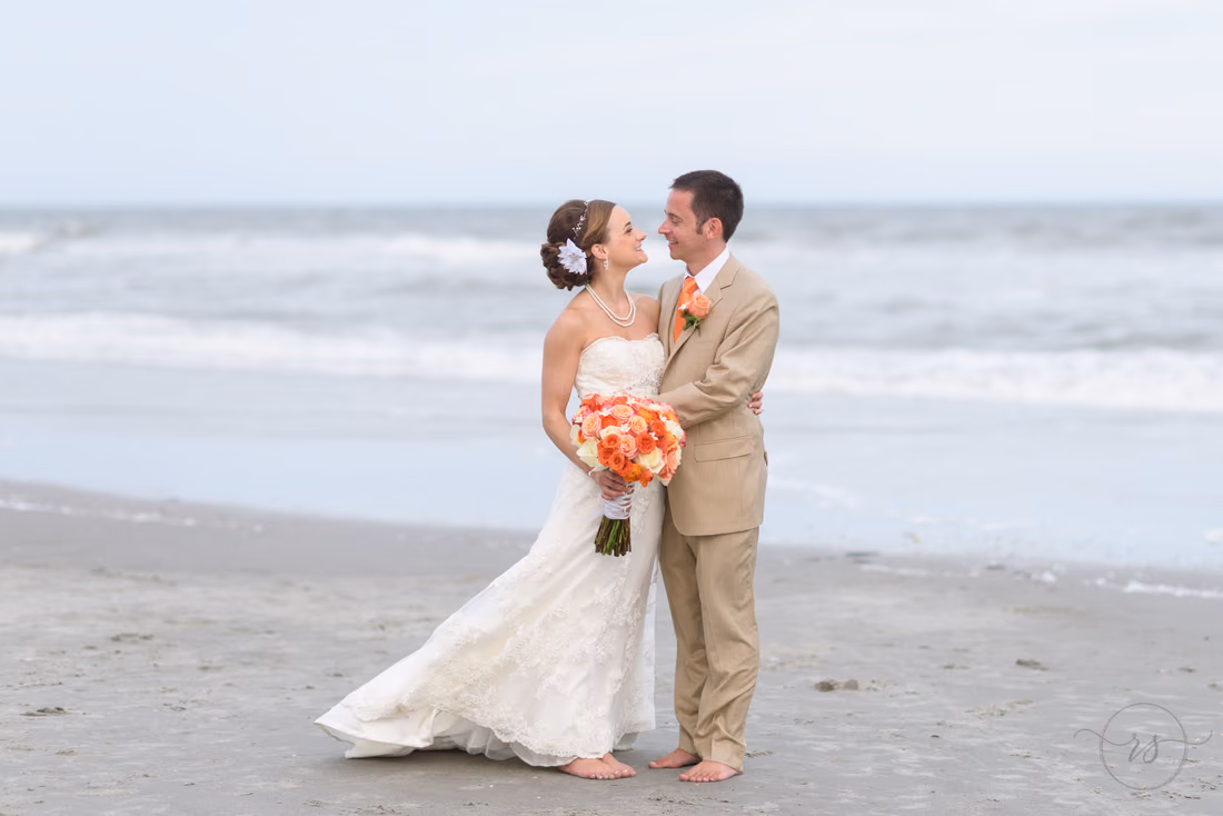 Couple smiling in front of the ocean - Hilton Myrtle Beach Resort at Kingston Resorts