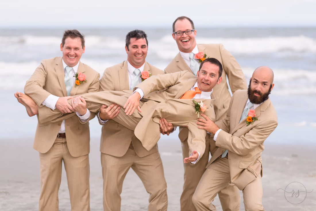 Groomsmen lifting up the groom - Hilton Myrtle Beach Resort at Kingston Resorts