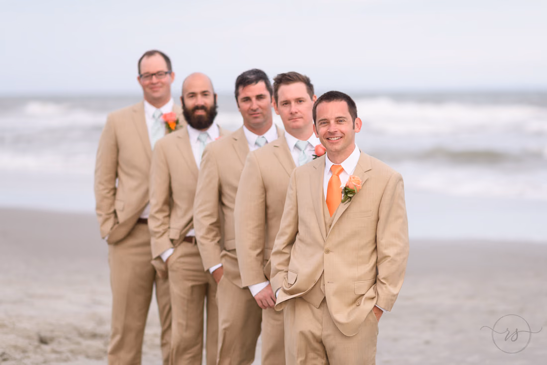 Groomsmen posing in line with groom in focus - Hilton Myrtle Beach Resort at Kingston Resorts